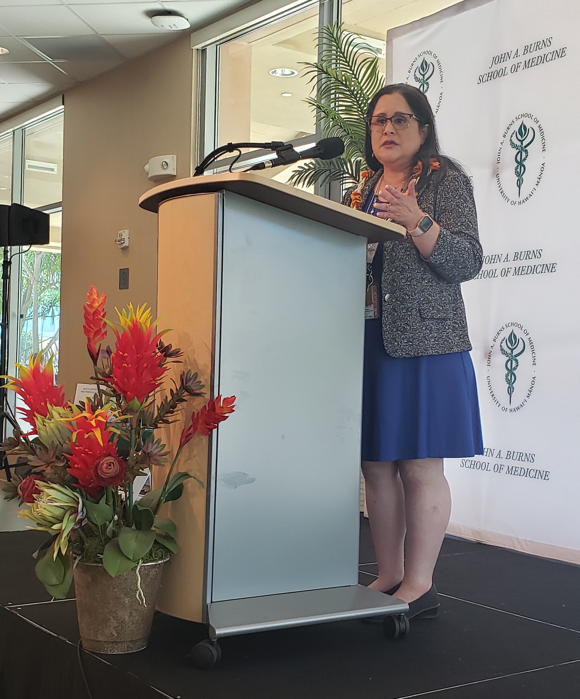 John A. Burns School of Medicine Dean Lee Buenonsejo-Lum Dr. Lee Buenconsejo-Lum at podium