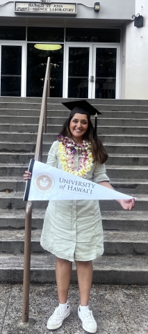 Manya Singh holding University of Hawaii banner