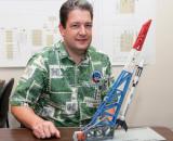 Luke Flynn with model of rocket
