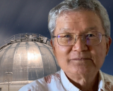 Dr. Alan Tokunaga headshot with telescope